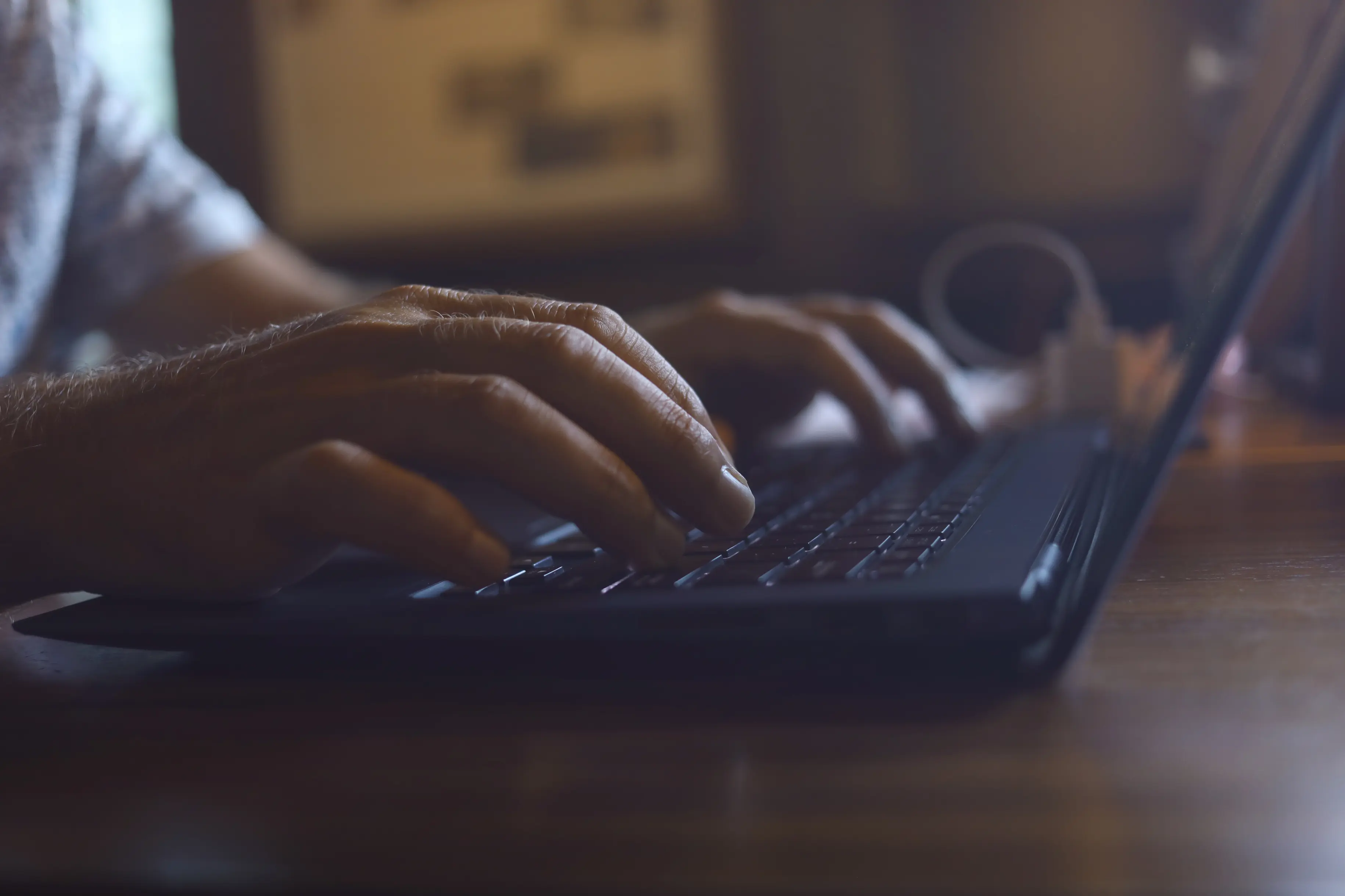 Close-up of a hand using a laptop