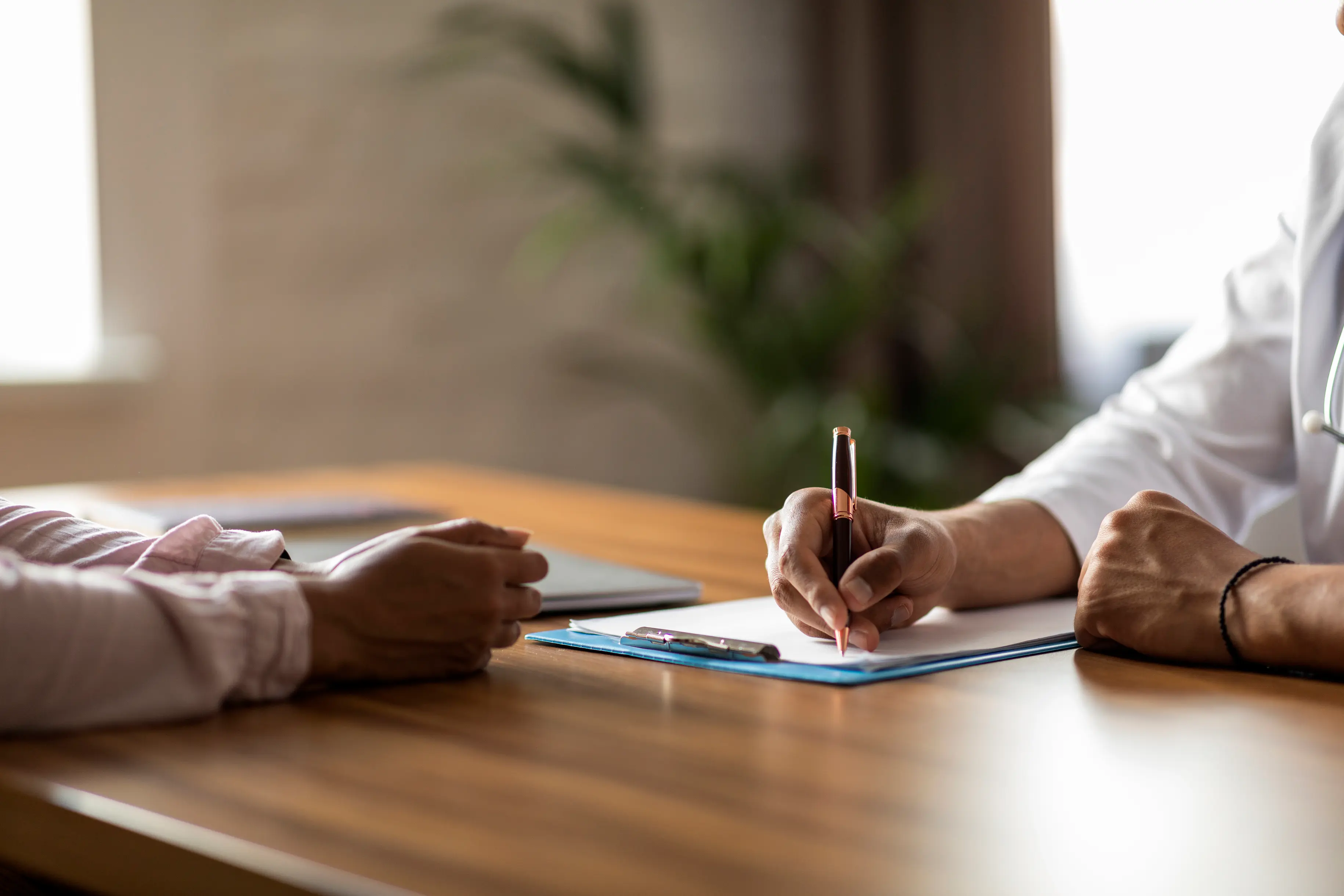Doctor and patient sitting at a table in consultation