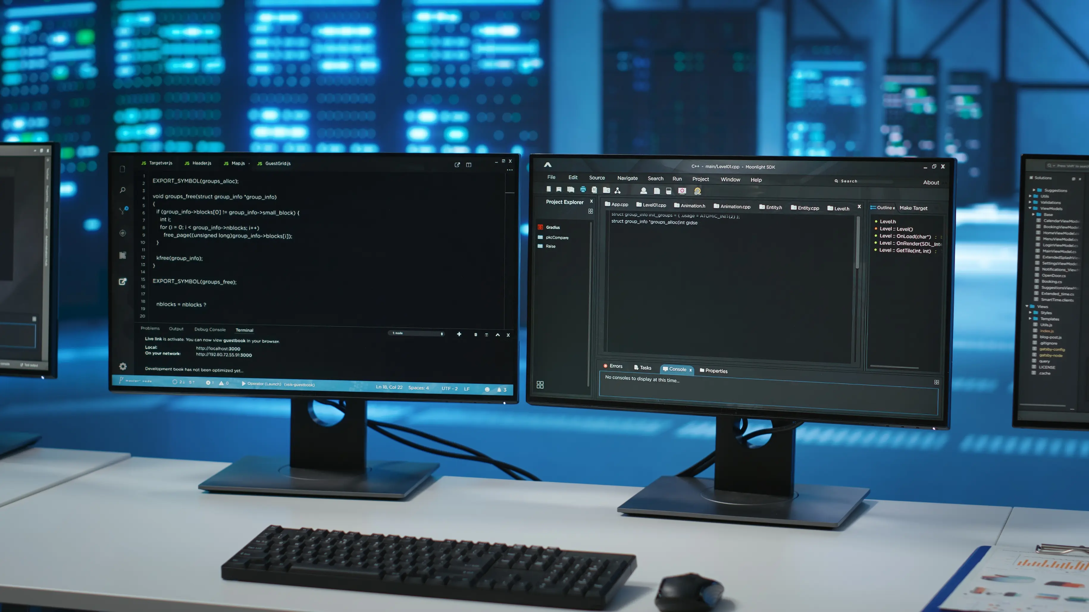 Dual monitors showing code and data, front view in a data center