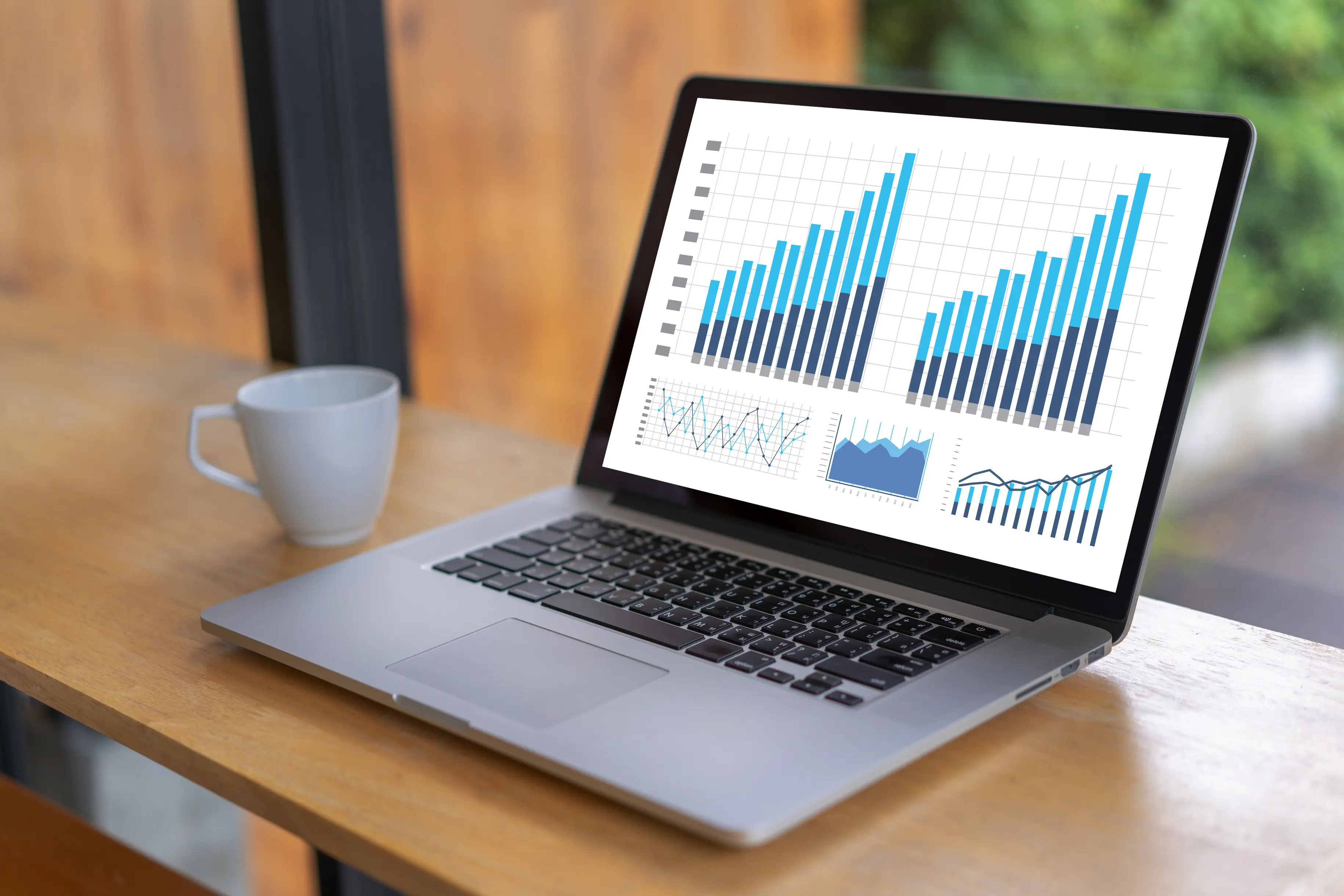 Laptop showing two data graphs side by side