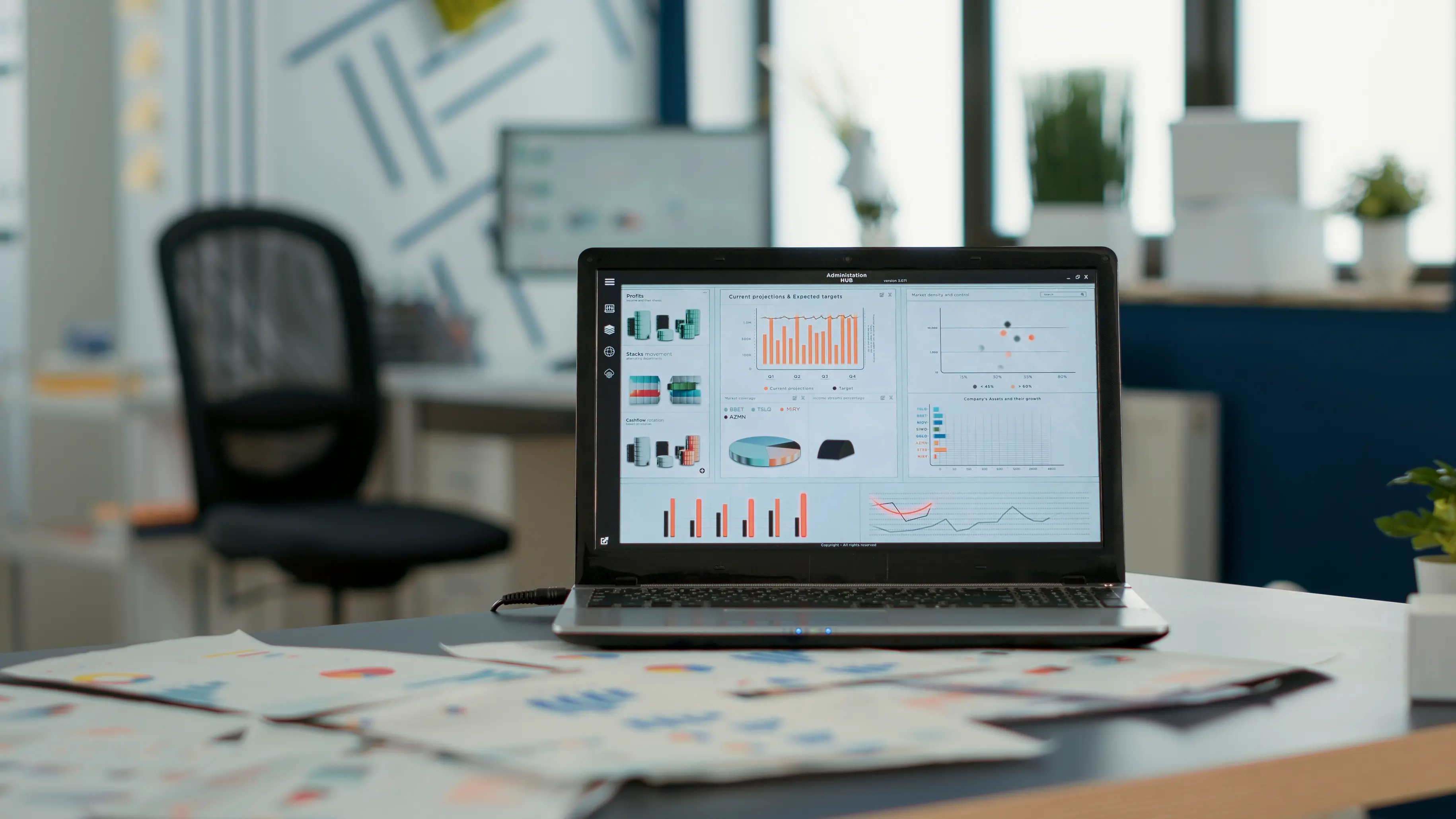 Laptop with data dashboard and data sheets, front view