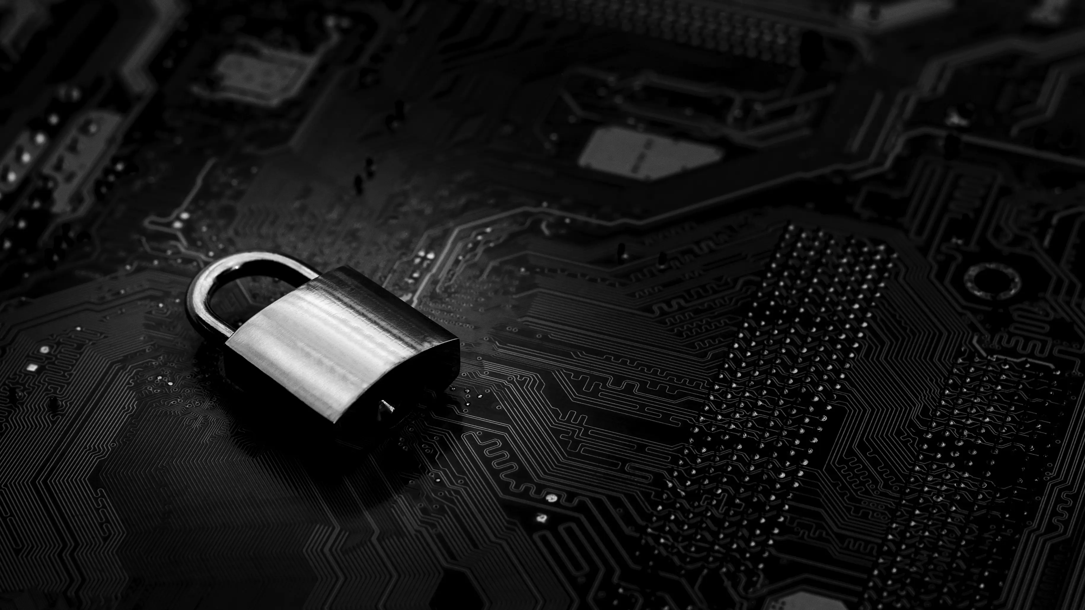 Padlock lying on a gray motherboard